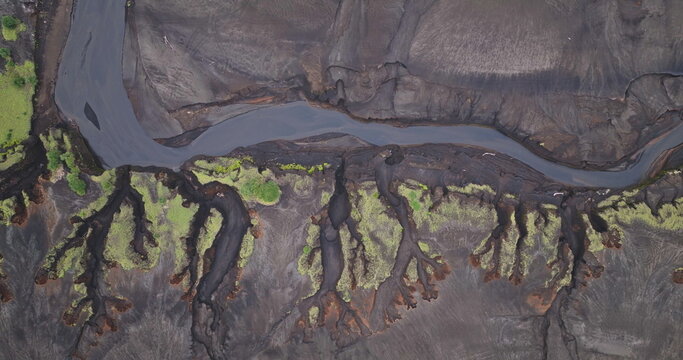Fototapeta Fiji, Tana Island: Winding river flowing through volcanic terrain in Port Resolution. Wild nature landscape travel background. Drone flight aerial top down view