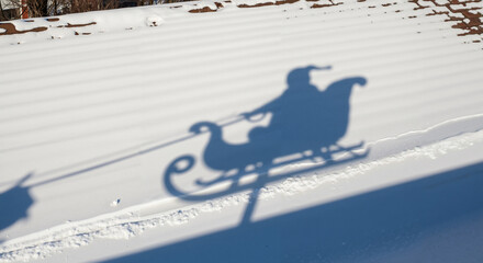 Extended shadow of Santa's sleigh gliding across the snowy roof  