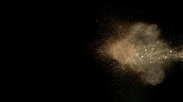 Super Slow Motion Shot of Flying Soil , Isolated on Black Background , Filmed on High Speed Cinematic Camera at 1000 FPS