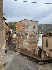 Collesano, a historic Sicilian mountain town in the Madonie Mountains, featuring narrow stone streets, traditional houses, and the Church of San Pietro, Sicily, Italy. Italian town in hills
