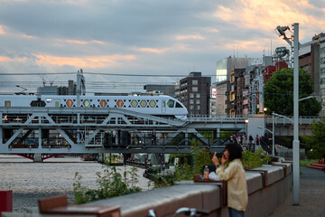 A high-speed train travels over a bridge over a river