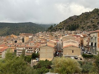 Obraz premium Collesano, a historic Sicilian mountain town in the Madonie Mountains, featuring narrow stone streets, traditional houses, and the Church of San Pietro, Sicily, Italy. Italian town in hills