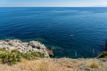 Capo Zafferano Italian coastal promontory and lighthouse by the Tyrrhenian Sea in Bagheria, Sicily Italy with rugged cliffs lush Mediterranean flora crystal clear water