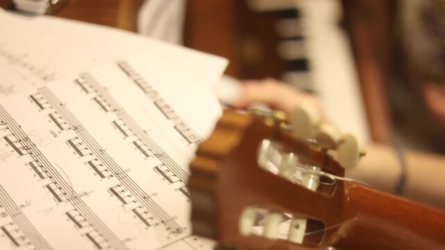 classical guitar. teenager with notes in hands, studying,  professional classical guitar and piano. music lesson in class music teacher  with talented student practicing Moscow Russia 10.01.2025