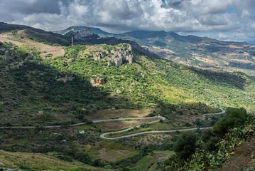 Fotobehang Smalle Straten Caltavuturo, a historic Sicilian mountain town in the Madonie Mountains, featuring its medieval castle, charming narrow streets, and traditional stone houses, Sicily, Italy. Italian town in hills  © Chawran