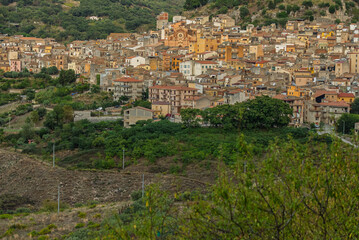 Obraz premium Collesano, a historic Sicilian mountain town in the Madonie Mountains, featuring narrow stone streets, traditional houses, and the Church of San Pietro, Sicily, Italy. Italian town in hills