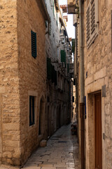 Fototapeta premium Charming narrow street in a historic stone town