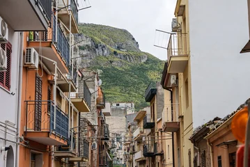 Fototapete Rund Enge Straßen Collesano, a historic Sicilian mountain town in the Madonie Mountains, featuring narrow stone streets, traditional houses, and the Church of San Pietro, Sicily, Italy. Italian town in hills  © Chawran