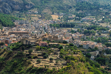 Obraz premium Collesano, a historic Sicilian mountain town in the Madonie Mountains, featuring narrow stone streets, traditional houses, and the Church of San Pietro, Sicily, Italy. Italian town in hills