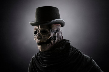 Creepy figure with black vintage top hat in the dark