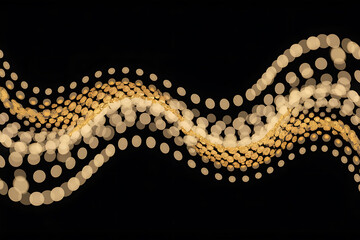 Golden particles form a flowing, wavy pattern against a dark background, creating a dynamic visual effect.