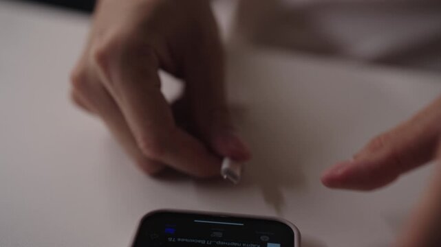 Close-up hands of unrecognizable man connecting OTG cable to smartphone, enabling data transfer, device charging and peripheral connection, showcasing mobile connectivity and technology integration.