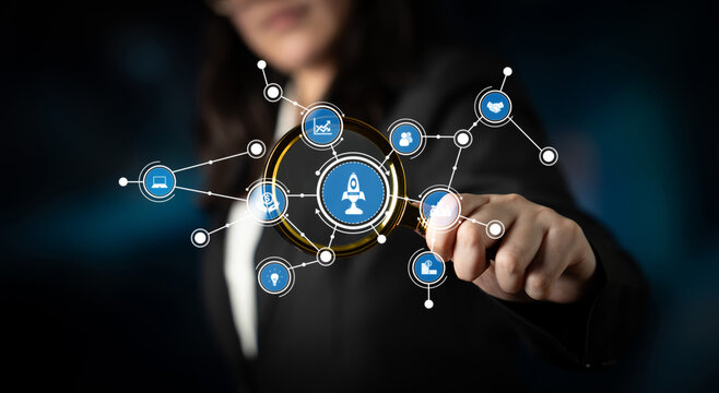 A business professional engages with holographic digital network icons in a modern environment, symbolizing innovation and strategic growth in technology. Tessel - Powered by Adobe