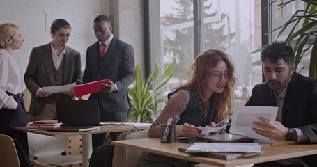 Diverse colleagues brainstorm and analyze data in a co working space coffee bar, fostering collaboration and innovation for their startup business. - Powered by Adobe