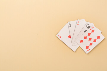 Poker chips and playing cards on color background, top view. Casino card game