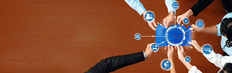 A diverse team collaborates around a table, utilizing digital tools for effective communication and strategy development in a business setting, showcasing teamwork and innovation. Amity