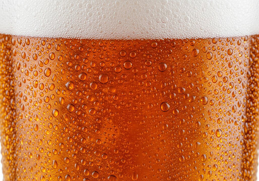 Refreshing golden beer with condensation and frothy head, perfect for summer advertising, bar promotions, or celebrating with friends on a hot day - Powered by Adobe