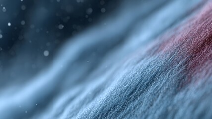Abstract close-up of blue and red textured fabric with snow particles, soft winter background