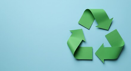 Recycling symbol cut out of kraft paper on green background, top view. Space for text