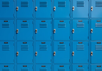A close-up view of a grid of bright blue school lockers with closed doors.