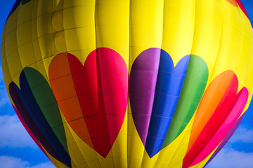 Yellow hot air balloon with multi-colored hearts,  close-up from the Albuquerque International...