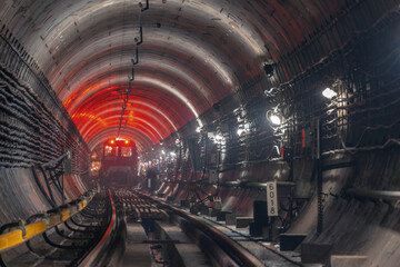 Subway Train in Underground Tunnel with Concrete Walls and Industrial Lighting