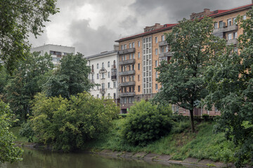 Residential Riverside in Minsk with Green Trees and Overcast Sky