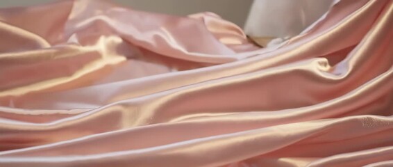 A luxurious and calming seamless loop of pink silk fabric waving slowly. This elegant, abstract background is perfect for Mother's Day, beauty products, fashion, or relaxation content. - Powered by Adobe