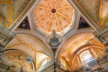 Ornate ceiling and dome with chandeliers and frescoes inside Collegiate Basilica of Our Lady of Guanajuato in Guanajuato, Mexico