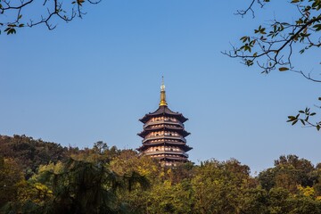 Pagoda Tower Nestled Among Lush Green Trees with Blue Sky in Hanzhou China