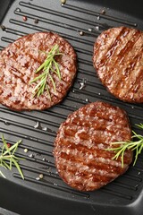 Pan with grilled patties and spices, top view