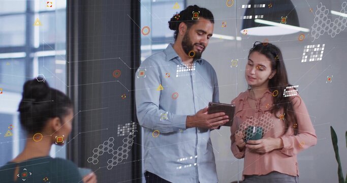 Visualizing data, mid adult male professional holding tablet in modern office, with coffee mug