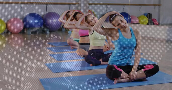 Fototapeta Stretching coach in sportswear leading neck stretch in studio with yoga mats, copy space