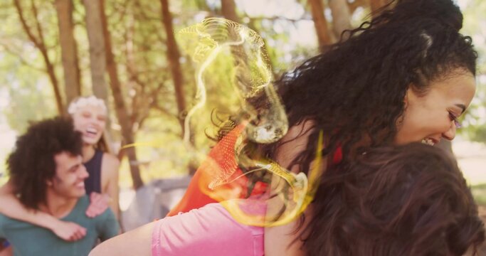 Dark-skinned man giving piggyback ride to partner in pine grove, with dappled sunlight, copy space