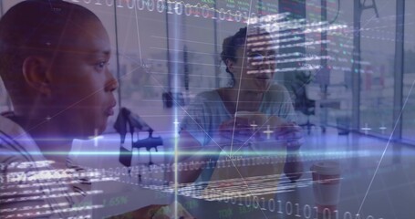 Sitting office colleagues holding sandwich and coffee under binary code overlay in office area