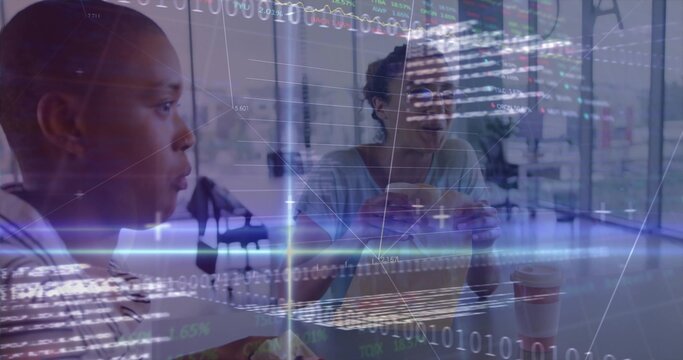 Sitting office colleagues holding sandwich and coffee under binary code overlay in office area