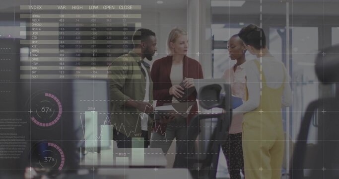 Discussing team of four reviewing stock charts on tablet in modern office, with laptop, documents