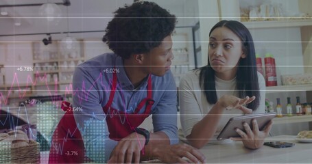 Reviewing sales figures, staff analyzing tablet at cafe counter, with pastry basket, smartphone
