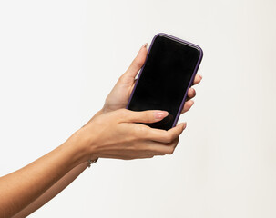 Women's palms holding a smartphone with a dark screen