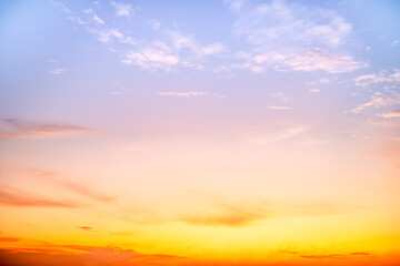 Sunset or sunrise sky with a vibrant gradient of orange, gold, and soft blue. Clear atmosphere with wispy clouds. Peaceful, natural light background. hope, freedom, new day and inspirational Concepts