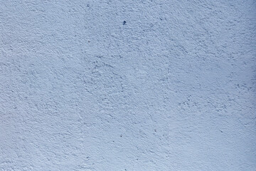 A blue wall with a rough texture