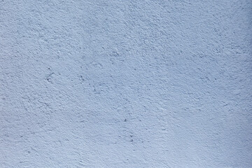 A blue wall with a rough texture