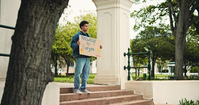 University, protest and student outdoor with poster for awareness, freedom and equality in education. Campus, college and man with sign, board and message for demonstration, justice and rights