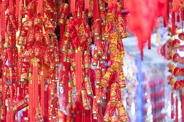 Naklejka premium Vibrant Red And Gold Decorations Hanging For Lunar New Year Celebration In Bright Outdoor Lighting With Festive And Cultural Elements Abundance