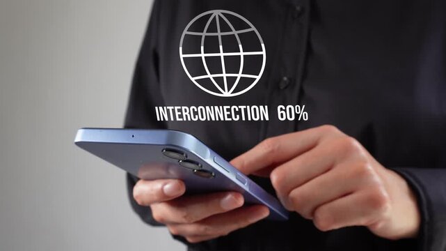 A female executive working on her cell phone and an animation of a filled globe with a percentage counter and the word "Interconnection"