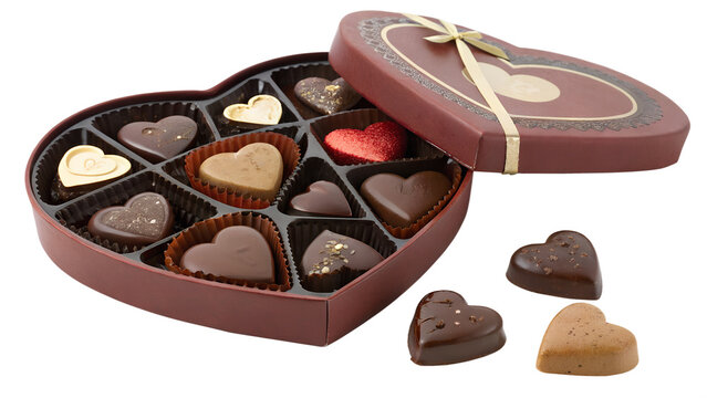 Heart shaped box of assorted gourmet chocolates with some chocolates scattered outside isolated on transparent background
