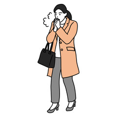 冬の通勤　手を温めるコート姿の女性