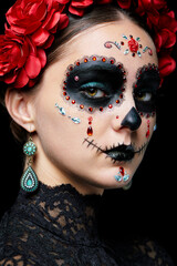 Halloween beauty close-up portrait of woman. Beautiful female face adorned with Santa Muerte makeup.