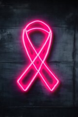 Pink neon ribbon symbol on dark wall for breast cancer awareness