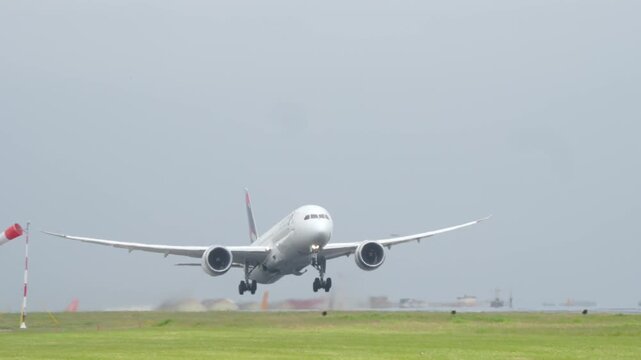 LISBON, PORTUGAL - APRIL 7, 2025: Frontal view of a LATAM Airlines Boeing 787 Dreamliner aircraft taking off from Lisbon Airport. The wide-body jet is seen mid-air with landing gear extended 4k